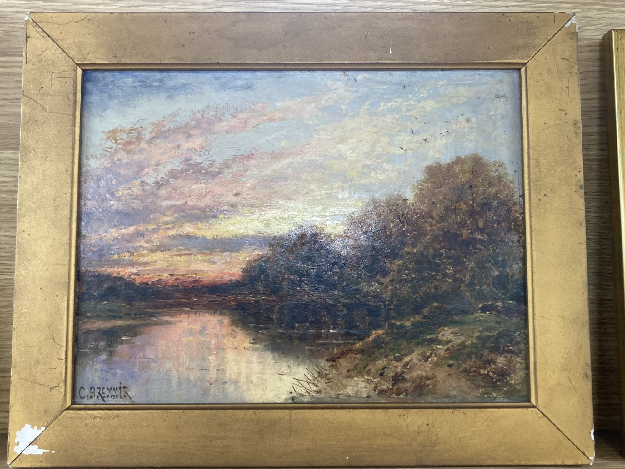 Carl Brennir (1850-1920), oil on mill board, River landscape at sunset, signed, 22 x 30cm